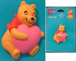 Plastic Winnie the Pooh holding a Heart