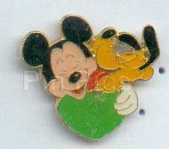 Pluto giving Mickey a kiss